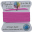 Pink thread on a card with Magnolia Bead Company branding against a wooden background