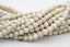 6mm Golden Matrix Creamy White Magnesite Faceted Round Beads -15.5 inch strand