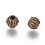 Bronze or Antique Silver, 4mm corrugated bicone. Sold per pkg of 100