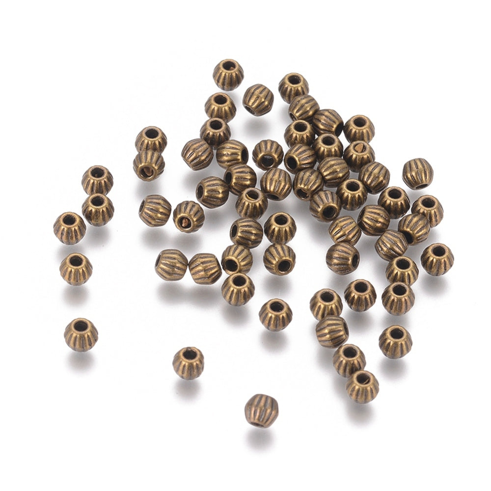 Bronze or Antique Silver, 4mm corrugated bicone. Sold per pkg of 100