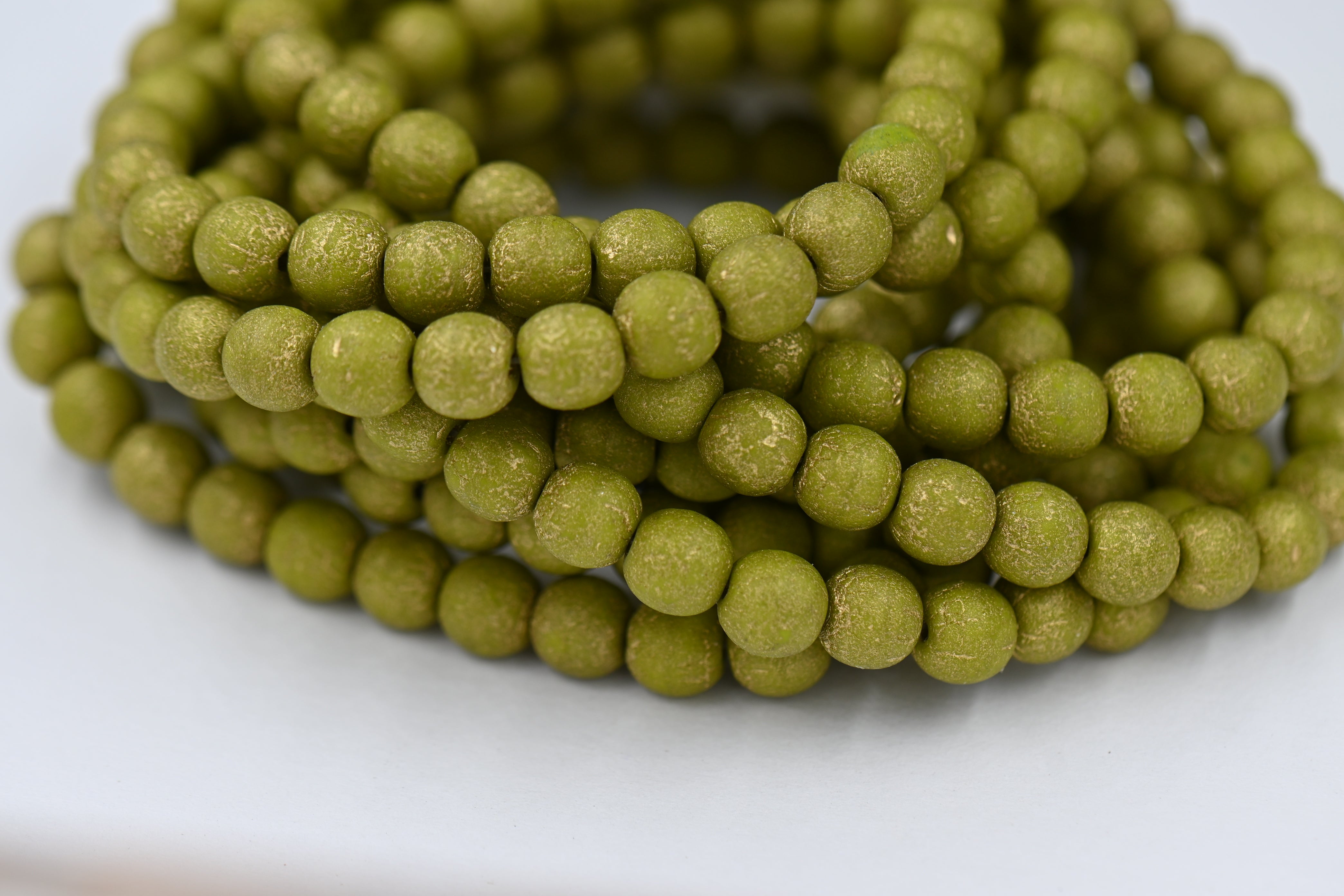 Czech 6mm Round Druk Peridot with an Etched Finish and a Gold Wash, 60