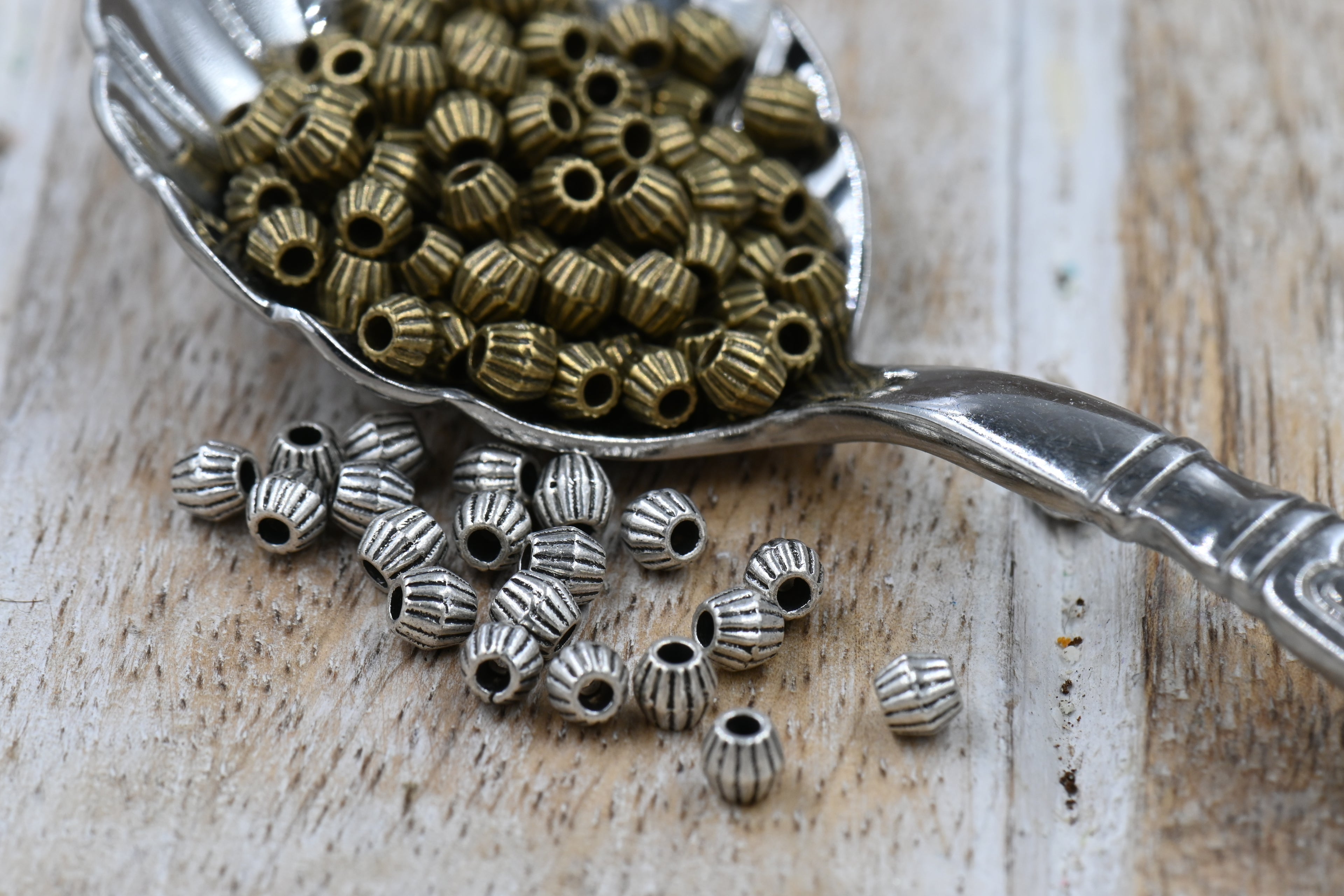 Bronze or Antique Silver, 4mm corrugated bicone. Sold per pkg of 100