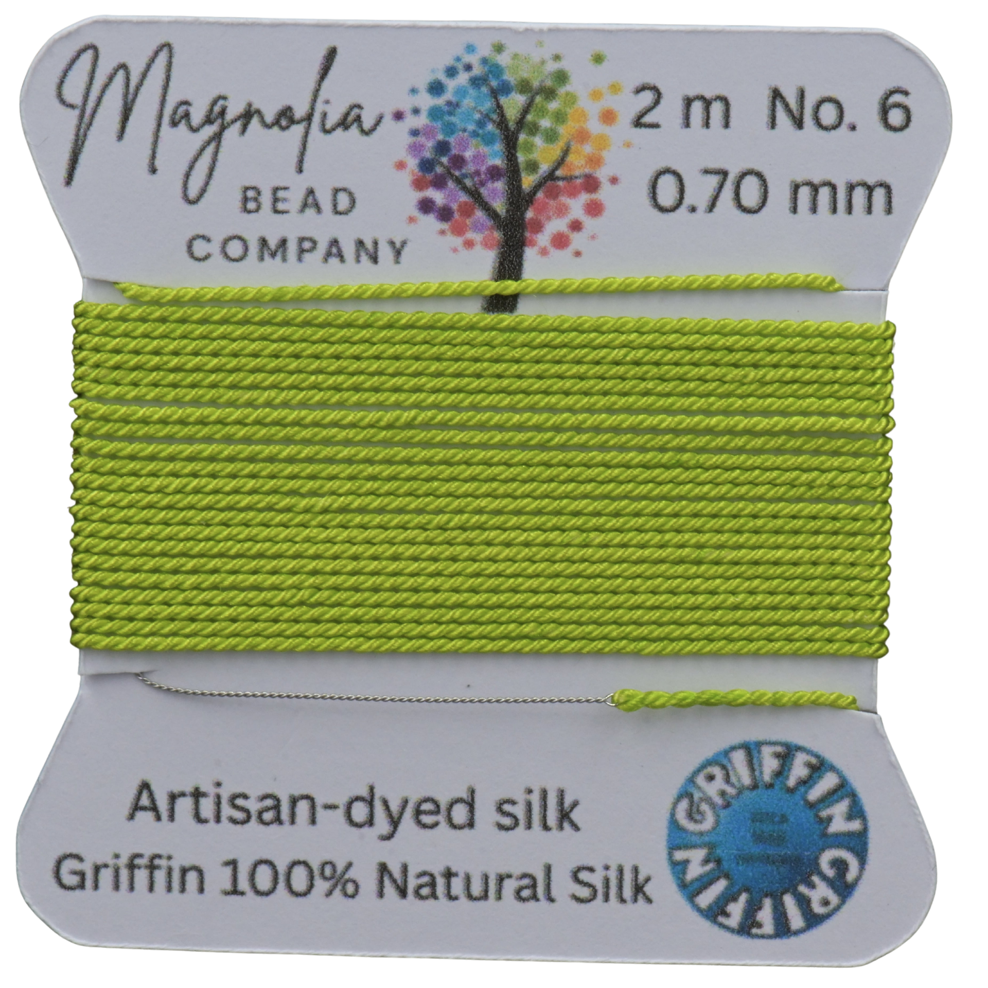 Lime green thread on a card with 'Magnolia Bead Company' branding against a wooden background