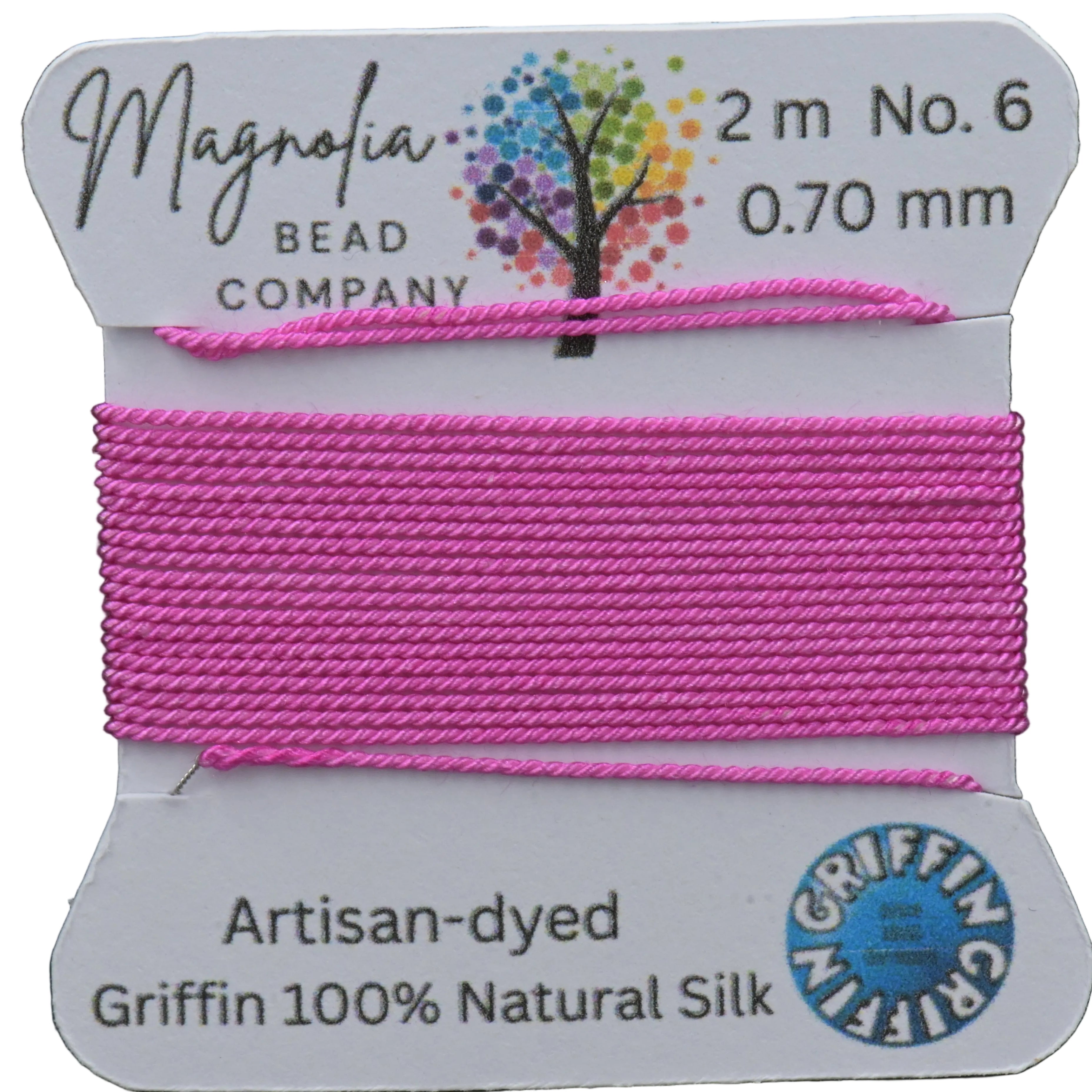 Pink thread on a card with Magnolia Bead Company branding against a wooden background