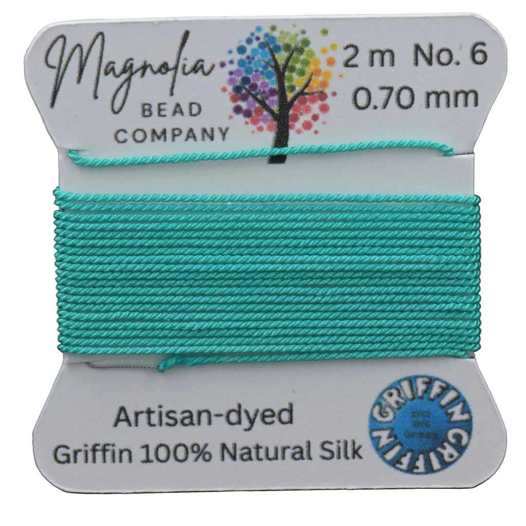 Turquoise thread on a Magnolia Bead Company label with brand details.