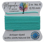 Turquoise thread on a Magnolia Bead Company label with brand details.