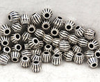 Bronze or Antique Silver, 4mm corrugated bicone. Sold per pkg of 100