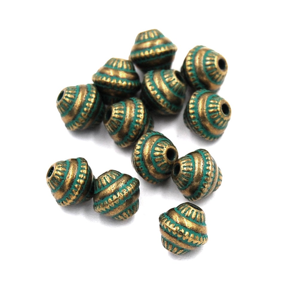 Antique Bronze/Green, 8mm bicone.  Sold per pkg of 25